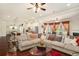 Open-concept living area with a spacious sectional, hardwood floors, and views into the kitchen and dining areas at 6861 Louis Dr, Locust Grove, GA 30248