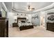Spacious main bedroom with decorative tray ceilings, a ceiling fan, and a king bed at 6861 Louis Dr, Locust Grove, GA 30248