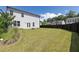 Spacious backyard featuring lush green grass, a fire pit, and a privacy fence at 522 Evans Ln, Woodstock, GA 30188