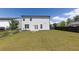 Large backyard featuring a fire pit and a fence with well-maintained lawn at 522 Evans Ln, Woodstock, GA 30188