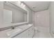 Bathroom featuring double sinks with chrome faucets and a tub with white tile at 522 Evans Ln, Woodstock, GA 30188