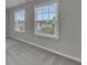 Bright bedroom featuring neutral carpet and two bright windows at 522 Evans Ln, Woodstock, GA 30188