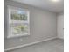 Neutral bedroom featuring a window with blinds and gray carpet at 522 Evans Ln, Woodstock, GA 30188