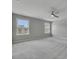 Spacious bedroom with neutral carpet, ceiling fan and two bright windows at 522 Evans Ln, Woodstock, GA 30188