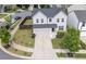A charming two-story home features a manicured lawn, driveway, attached two-car garage, and lush landscaping at 522 Evans Ln, Woodstock, GA 30188