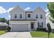 Charming two-story home with a gray exterior, well-maintained lawn, and a two-car garage on a sunny day at 522 Evans Ln, Woodstock, GA 30188