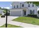 View of a lovely gray two-story home with a well-manicured lawn, and a two-car garage on a sunny day at 522 Evans Ln, Woodstock, GA 30188