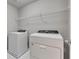 Laundry room featuring a washer, a dryer, and a shelf at 522 Evans Ln, Woodstock, GA 30188