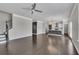 Open-concept living space featuring hardwood floors, staircase, and a glimpse into modern kitchen at 522 Evans Ln, Woodstock, GA 30188