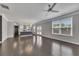 Open-concept living room showcasing hardwood floors, modern kitchen, and natural light at 522 Evans Ln, Woodstock, GA 30188