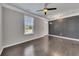 Comfortable living room featuring hardwood floors, a large window, and tasteful wall paneling at 522 Evans Ln, Woodstock, GA 30188