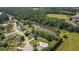 An aerial view showcases a community featuring a pool, pond, and multiple residential homes at 863 N Bay Overlook, Villa Rica, GA 30180