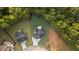 Aerial view of the property showcasing the house, landscaping, and surrounding wooded area at 863 N Bay Overlook, Villa Rica, GA 30180