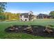 Beautiful backyard with a lush lawn, tasteful landscaping, and a patio area at 863 N Bay Overlook, Villa Rica, GA 30180