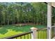 Manicured backyard featuring lush lawn, a fire pit, and a wooded landscape at 863 N Bay Overlook, Villa Rica, GA 30180
