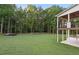 Expansive backyard features a lush lawn and a covered porch, perfect for outdoor relaxation at 863 N Bay Overlook, Villa Rica, GA 30180