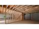 Unfinished basement with exposed wood beams and framing and concrete floors ready for design at 863 N Bay Overlook, Villa Rica, GA 30180