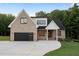 Beautiful exterior view of modern home with brick, black trim and a driveway at 863 N Bay Overlook, Villa Rica, GA 30180