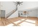Open-concept floor plan with vaulted ceilings and hardwood floors with kitchen in the background at 863 N Bay Overlook, Villa Rica, GA 30180