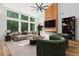 Bright living room with large windows, fireplace, modern fan, and stylish furnishings at 863 N Bay Overlook, Villa Rica, GA 30180