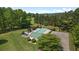 Aerial shot of a community pool surrounded by lush trees and green grass at 863 N Bay Overlook, Villa Rica, GA 30180