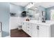 Bathroom featuring a double sink vanity, decorative mirror, and modern finishes at 1112 Sutton Dr, Mcdonough, GA 30252