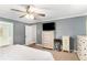 Bedroom featuring a ceiling fan, dresser, and an entertainment center at 1112 Sutton Dr, Mcdonough, GA 30252