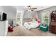 Cozy bedroom with carpet, a ceiling fan, and bright natural light, perfect for or guests at 1112 Sutton Dr, Mcdonough, GA 30252