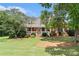 Charming brick home with a well-manicured lawn and inviting front porch with white picket fence detailing at 1112 Sutton Dr, Mcdonough, GA 30252