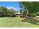 Traditional brick home with a large front yard featuring mature trees offering shade and curb appeal at 1112 Sutton Dr, Mcdonough, GA 30252