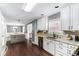 Bright kitchen featuring white cabinets, granite countertops, and stainless steel appliances at 1112 Sutton Dr, Mcdonough, GA 30252