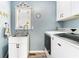 Functional laundry room with white cabinets, sink, and a modern washer and dryer at 1112 Sutton Dr, Mcdonough, GA 30252