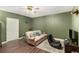 Living room with wood-look flooring, neutral walls, a ceiling fan and a comfortable couch at 1112 Sutton Dr, Mcdonough, GA 30252