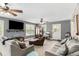 Spacious living room with gray walls, plenty of light, ceiling fans, and comfortable furnishings at 1112 Sutton Dr, Mcdonough, GA 30252