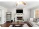 Comfortable living room with a brick fireplace, hardwood floors, and neutral decor for a welcoming atmosphere at 1112 Sutton Dr, Mcdonough, GA 30252