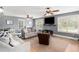 Comfortable living room featuring a neutral color palette, lots of natural light, and ceiling fans at 1112 Sutton Dr, Mcdonough, GA 30252