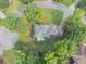 Overhead view of a residence with a spacious yard, trees and a paved driveway at 1245 Smokehouse Trl, Cumming, GA 30041