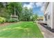 Large backyard features a wooden deck, shade treehouse and lush green lawn at 1245 Smokehouse Trl, Cumming, GA 30041