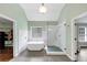 Bathroom featuring a freestanding tub, glass shower, light fixture, and tiled floors at 1245 Smokehouse Trl, Cumming, GA 30041