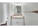 A powder room featuring tile floors, white vanity with granite countertop and chrome faucet at 1245 Smokehouse Trl, Cumming, GA 30041