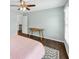 Bright bedroom with hardwood floors, light blue walls and a ceiling fan at 1245 Smokehouse Trl, Cumming, GA 30041