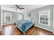 Bedroom with hardwood floors, ceiling fan, and a large window offering ample natural light at 1245 Smokehouse Trl, Cumming, GA 30041