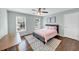 Cozy bedroom featuring a ceiling fan, neutral-toned walls, hardwood floors and large area rug at 1245 Smokehouse Trl, Cumming, GA 30041