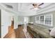 Spacious bedroom with tray ceiling, windows, and hardwood floors and adjacent rooms at 1245 Smokehouse Trl, Cumming, GA 30041