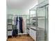 Walk-in closet features shelving and clothing racks for organized storage at 1245 Smokehouse Trl, Cumming, GA 30041