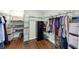 Walk-in closet features shelving and a safe for secure storage solutions at 1245 Smokehouse Trl, Cumming, GA 30041
