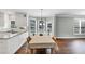 A dining room featuring hardwood floors, many windows, a dining table and white trim at 1245 Smokehouse Trl, Cumming, GA 30041