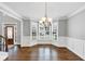 Formal dining room featuring a bay window, hardwood floors, and decorative moldings; perfect for entertaining guests at 1245 Smokehouse Trl, Cumming, GA 30041