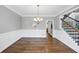 Formal dining room with wainscoting, hardwood floors and view into other rooms at 1245 Smokehouse Trl, Cumming, GA 30041