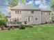 Back exterior of home with deck, bay window and neatly kept lawn at 1245 Smokehouse Trl, Cumming, GA 30041